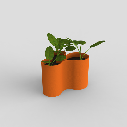 Coral Crest pot in orange used as a planter with green plants