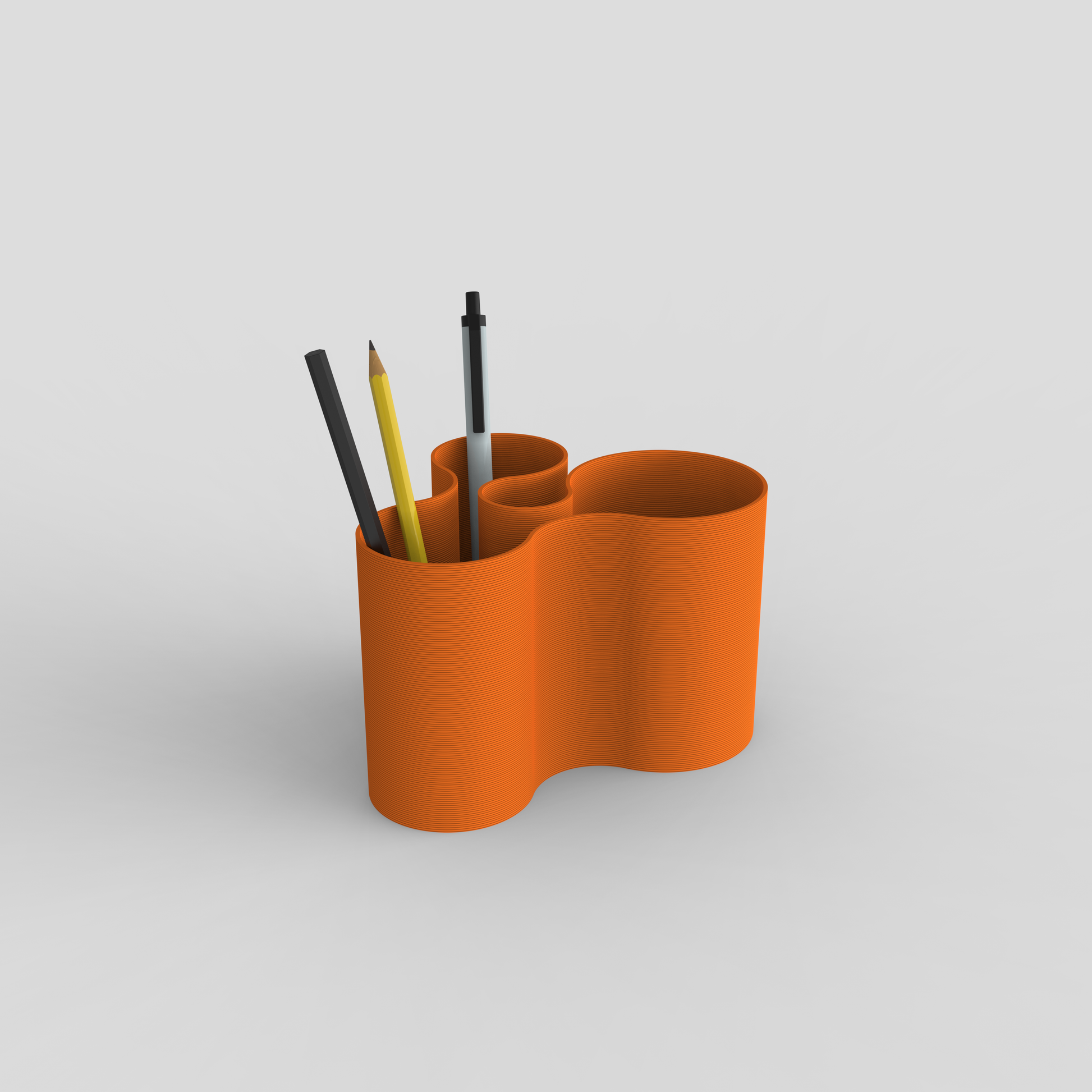 orange Coral Crest pot with pencils and pens.