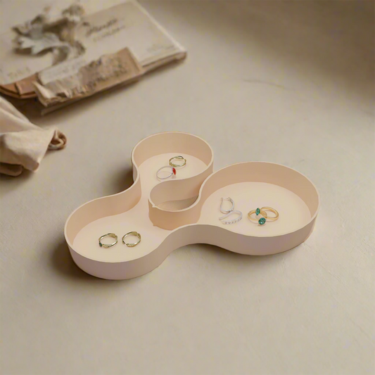 Coral crest tray in beige color with some jewellery in it