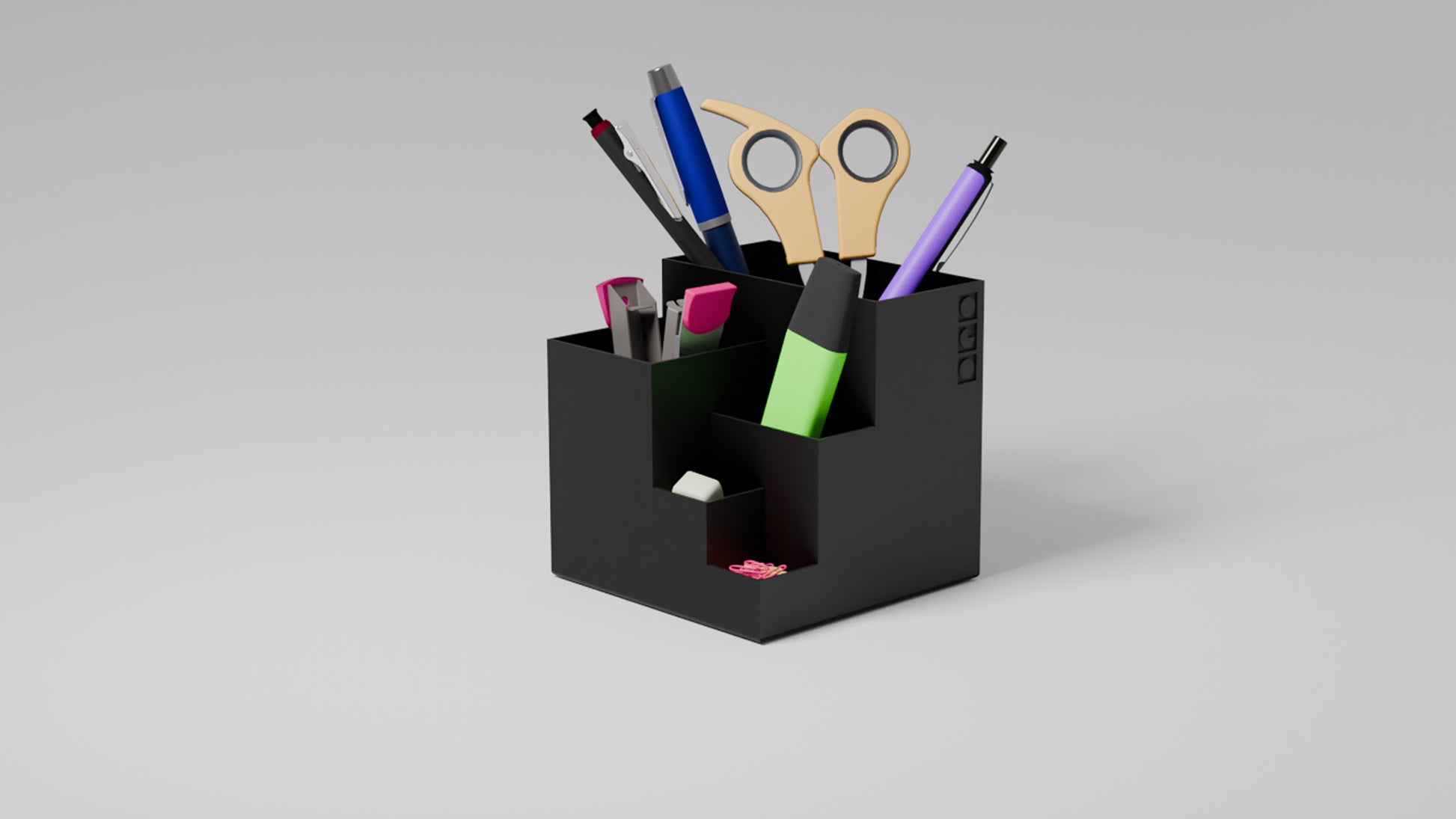 Organized black pen holder with designated slots for pens, markers, and accessories