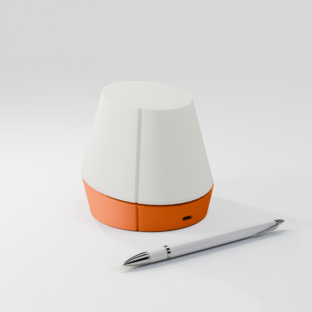 off shot of Litele portable lamp in orange color along with a pen