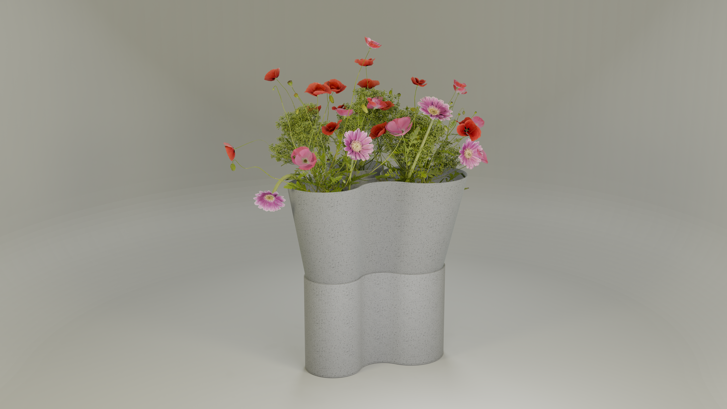 Paso Glo vase, a dual-sectioned marble coloured planter, unlit, holding red and pink flowers.