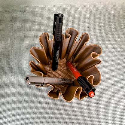 top view of coral vase with pens in bronze color