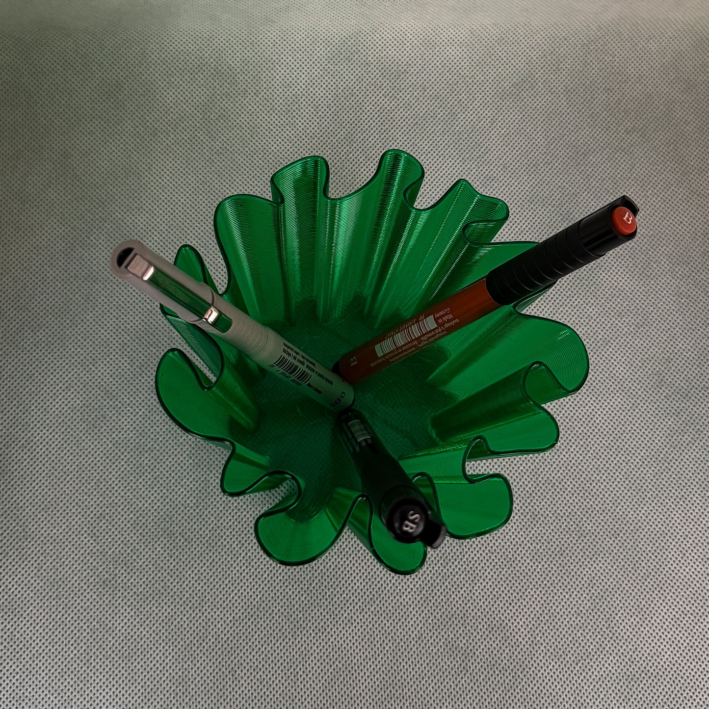 top view of coral vase with pens in green color
