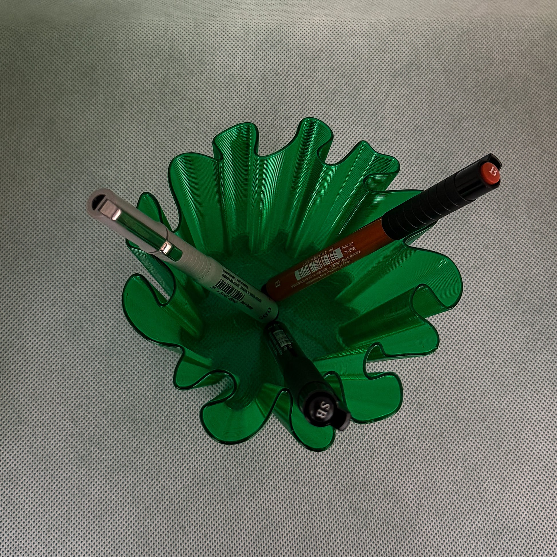 top view of coral vase with pens in green color