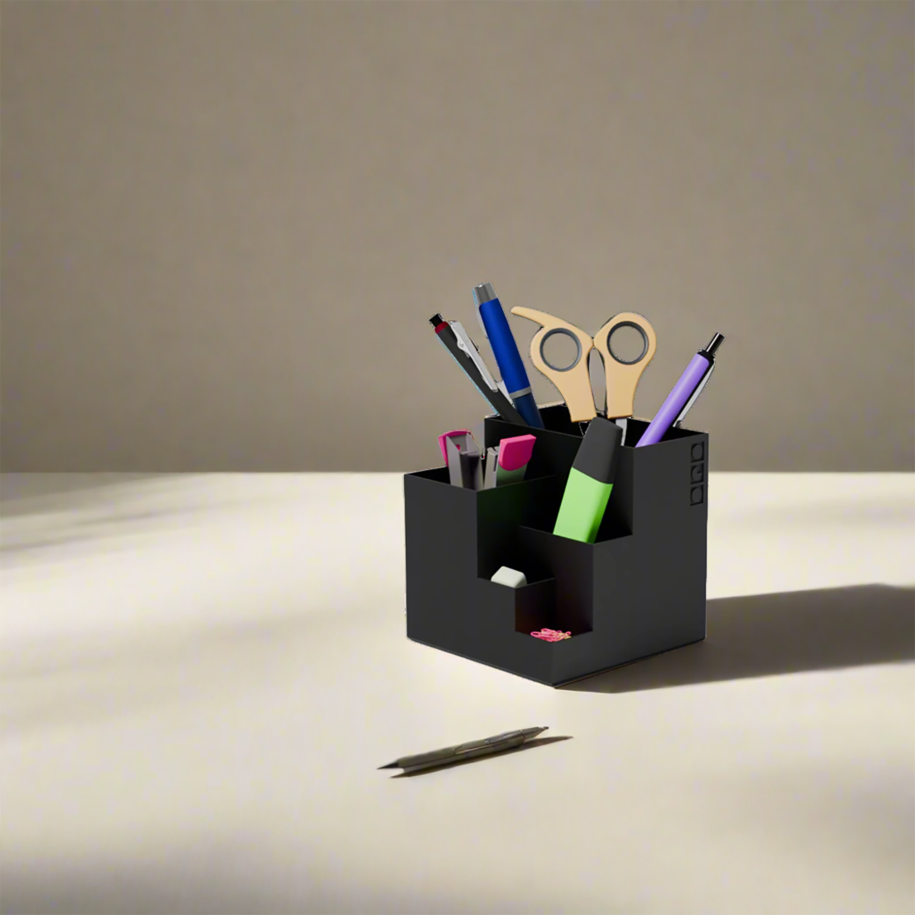 Cube stationary holder in black color with some stationary items in it