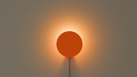 On shot of Halo Neo wall light in orange color with a halo effect on the wall behind