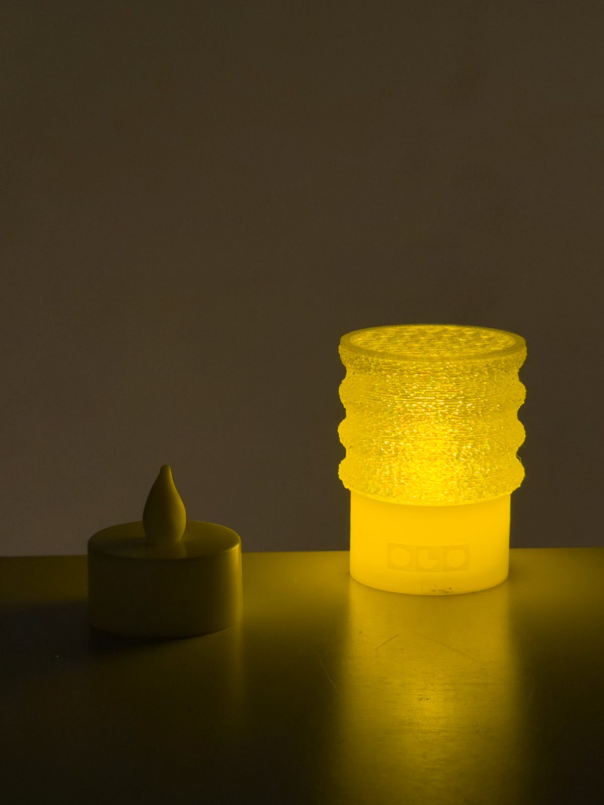 Mini twist lamp with a small candle light beside
