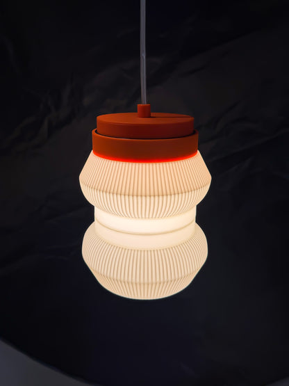 Angled On shot of orange base Stacko drop Pendant light on a dark background